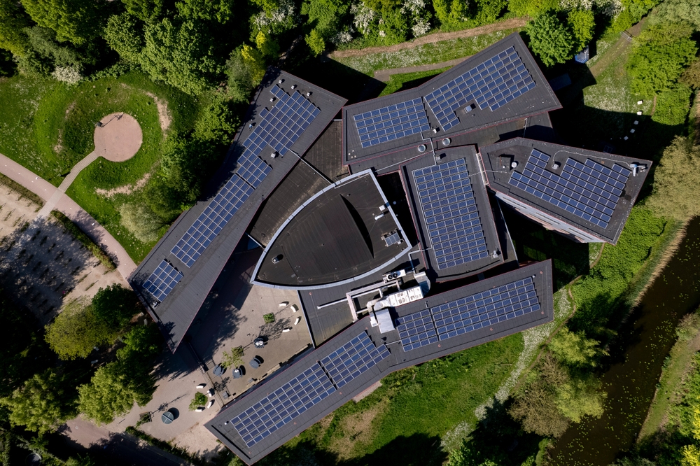 Top down view of high school building with rooftop full solar of solar panels